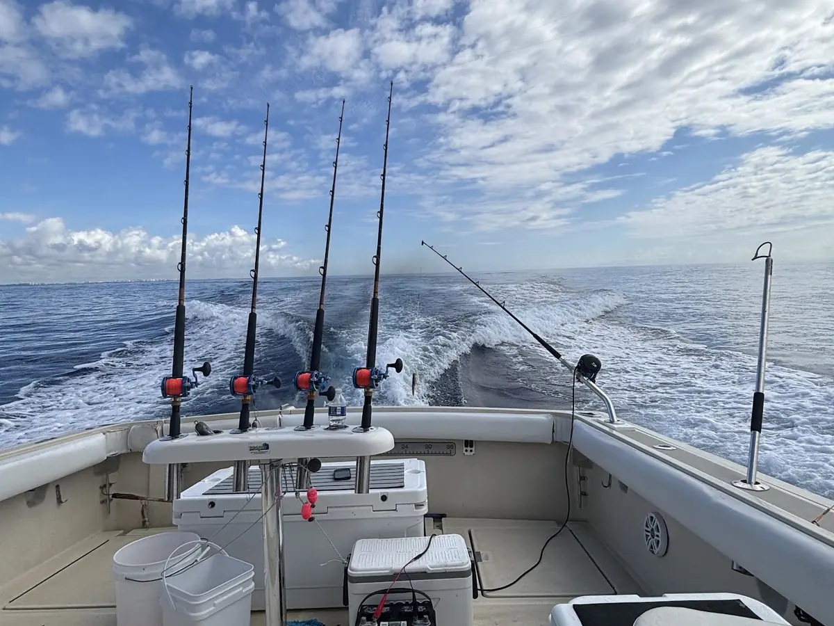 The rod spread set on the Gradyful boat under towering clouds off Pompano Beach