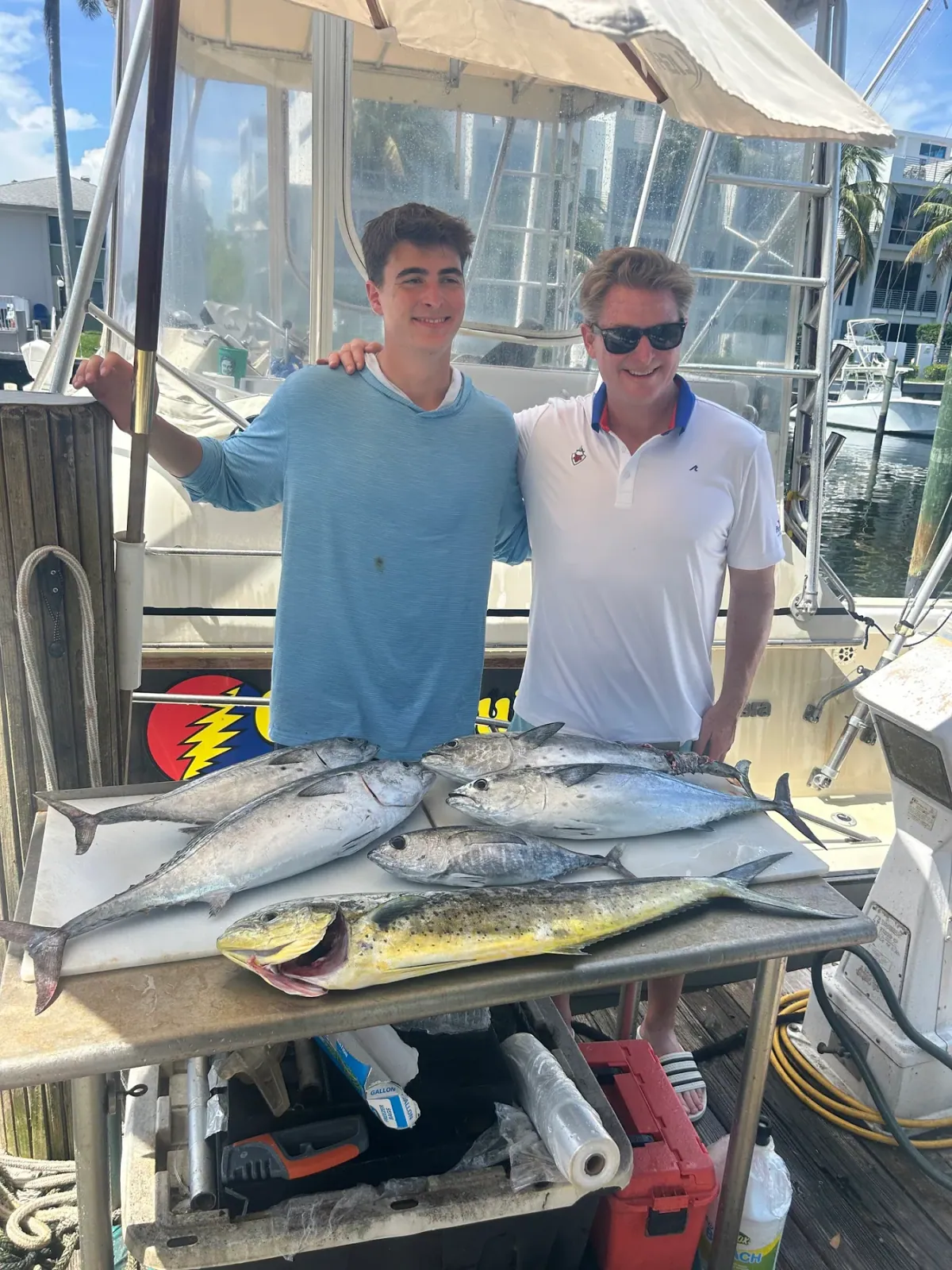 Blackfin tuna and mahi laid out along the gunwale of the Gradyful boat